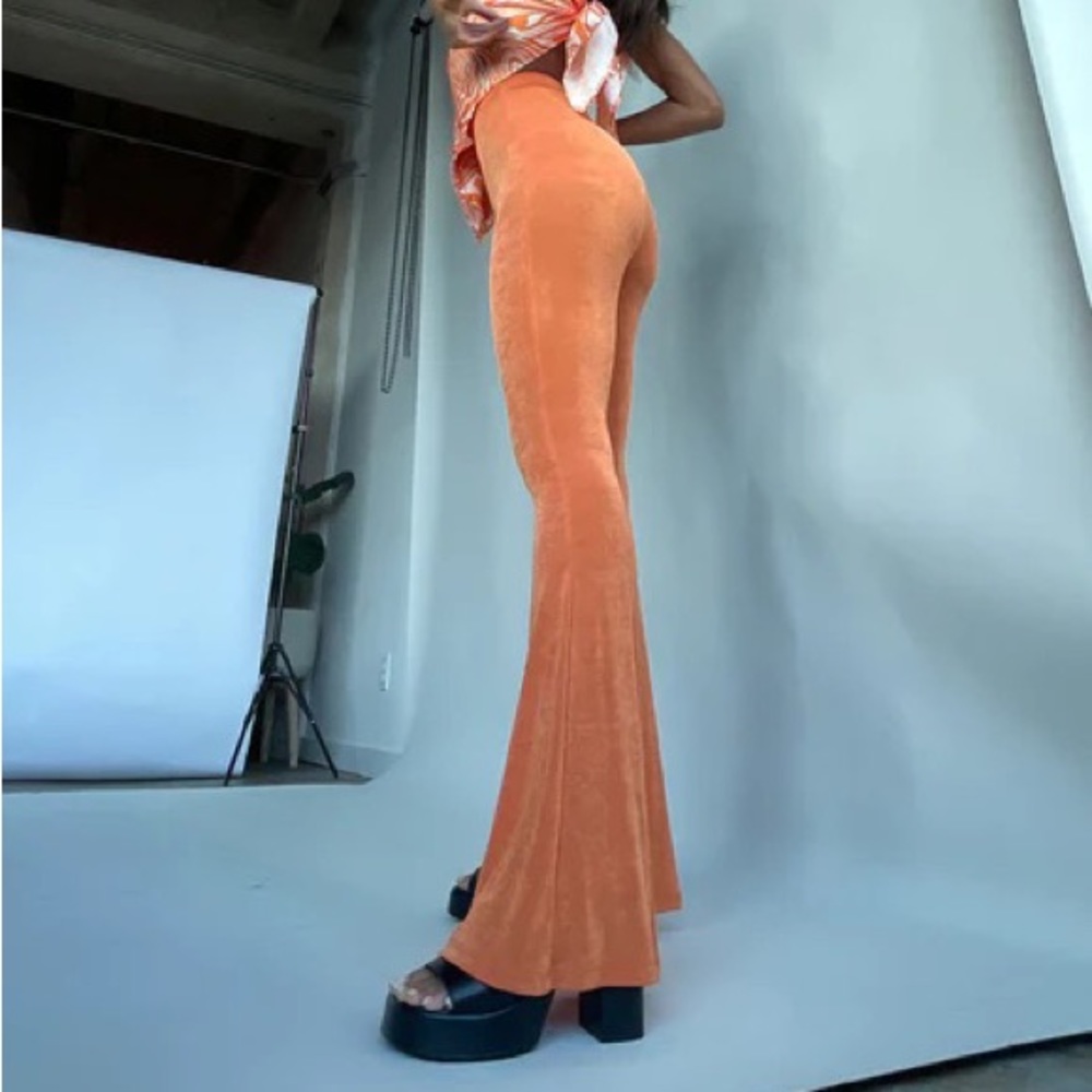 Matching orange mesh Princess Polly sat